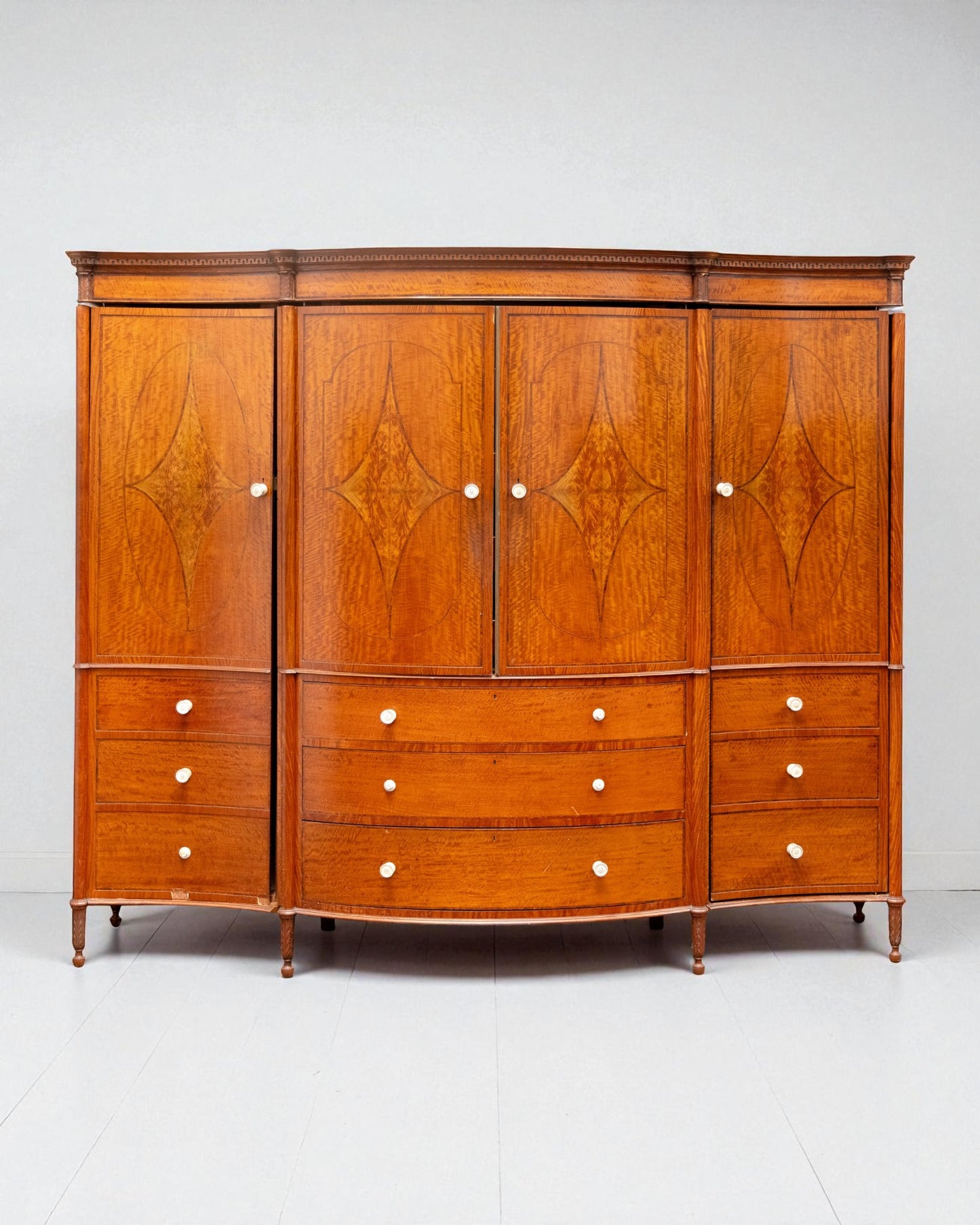 EDWARDIAN SATINWOOD INLAID AND CROSSBANDED SERPENTINE FRONTED WARDROBE
