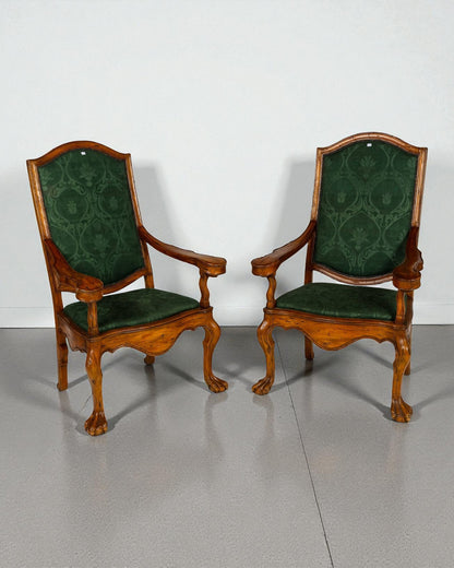Pair of high back armchairs , scrolled arm brackets, claw feet resting on spheres 20C