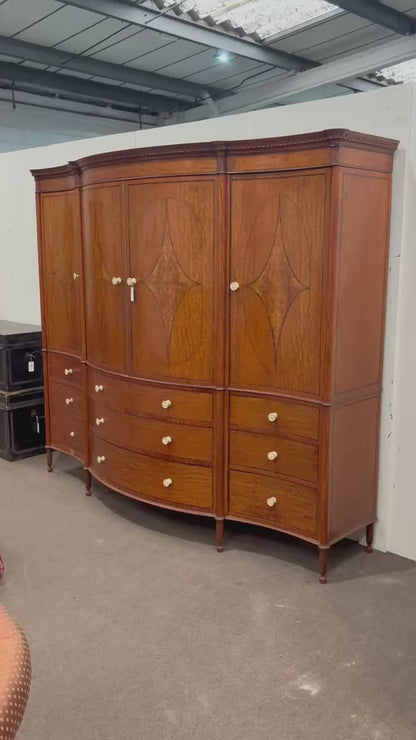 EDWARDIAN SATINWOOD INLAID AND CROSSBANDED SERPENTINE FRONTED WARDROBE